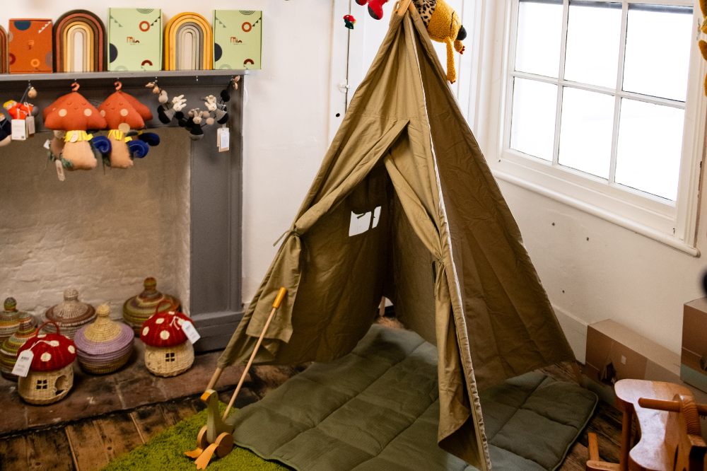 A children's green tent in a shop 