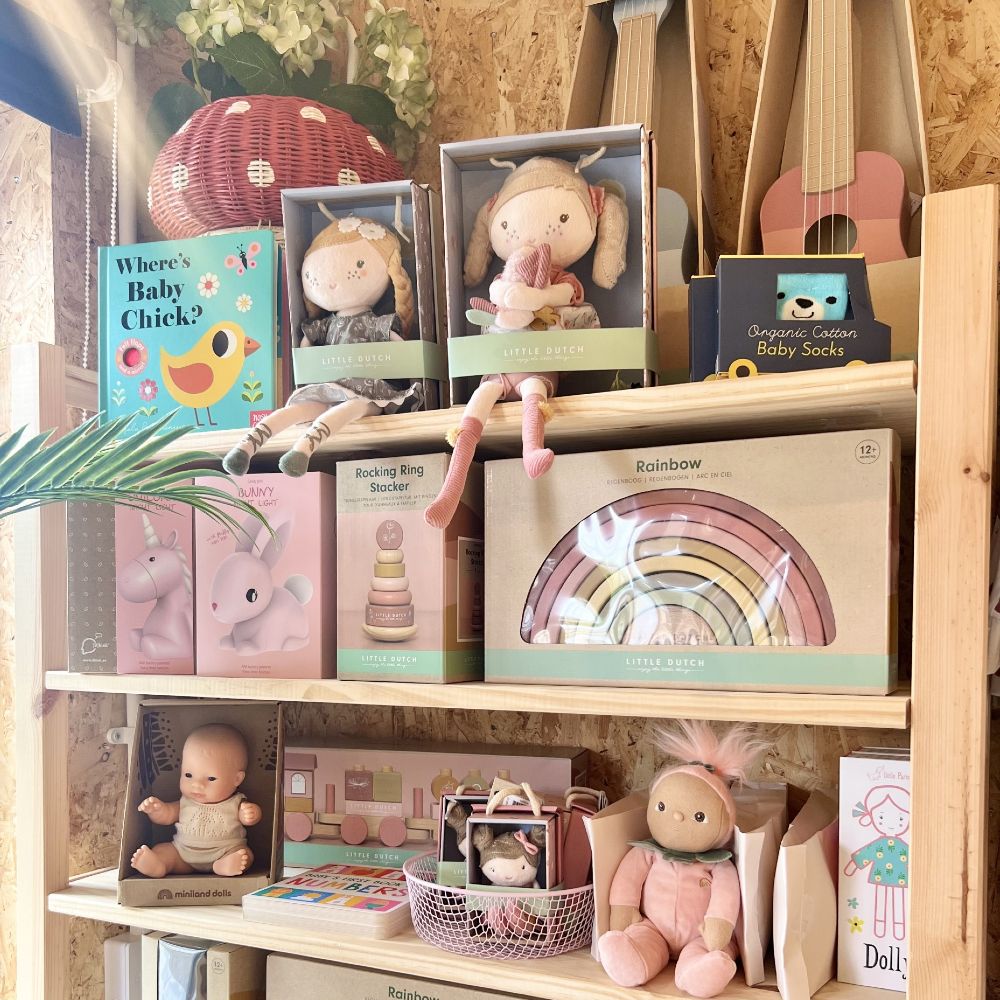 Wooden shelves displaying children's toys and gifts in a shop 