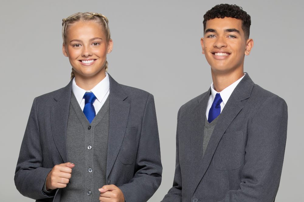 Two school pupils wearing unisex school blazers and uniform