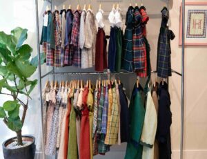 Children's clothes hung on rails in the new Il Porticciolo childrenswear boutique
