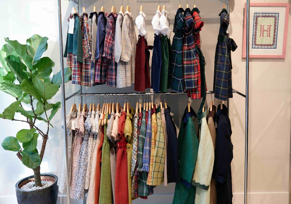 Children's clothes hung on rails in the new Il Porticciolo childrenswear boutique