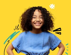 A Young girl stood against a yellow background wearing a blue top to promote the M&S x YoungMinds charity partnership to support young people's mental health