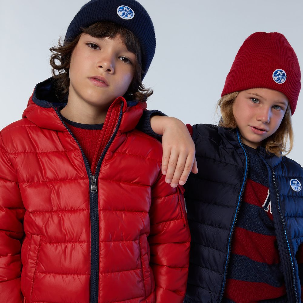Two young boys wearing hats and quilted coats by North Sails