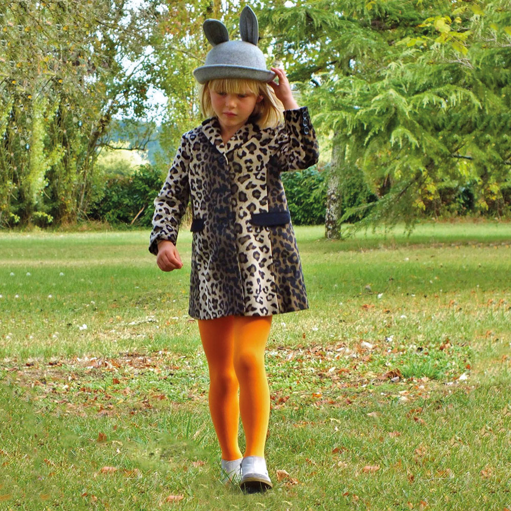 A young girl wearing a hat with ears, a leopard print dress and yellow tights by Country Kids 