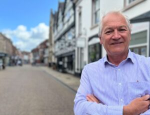 Andrew Goodacre CEO of BIRA stood on a high street of shops