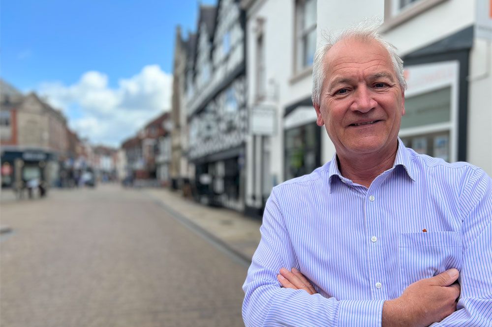 Andrew Goodacre CEO of BIRA stood on a high street of shops