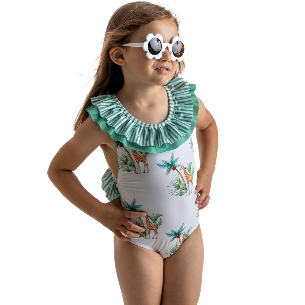 A young girl wearing flower sunglasses and a swimsuit 