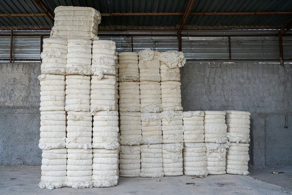 Piles of cotton bales stacked up