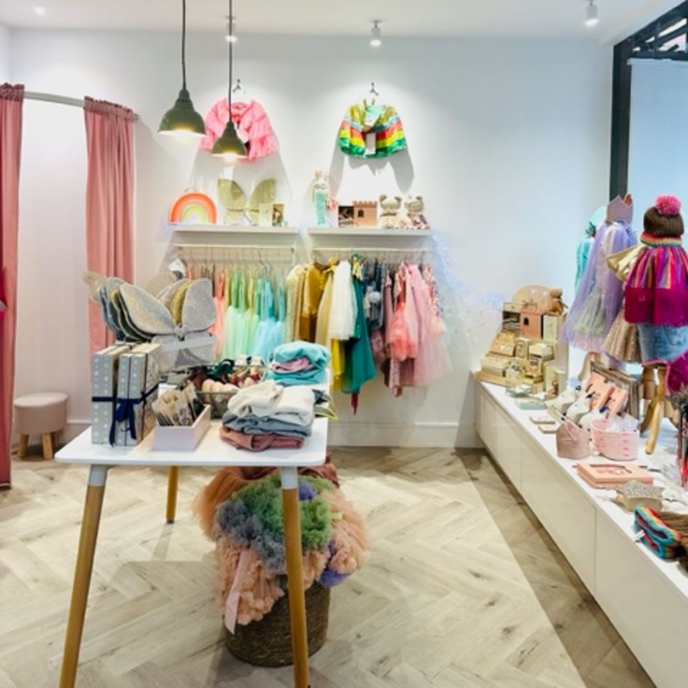 Children's dress-up clothes and accessories displayed inside a shop 