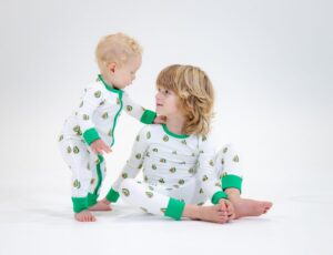 A baby and a young boy wearing avocado print pyjamas