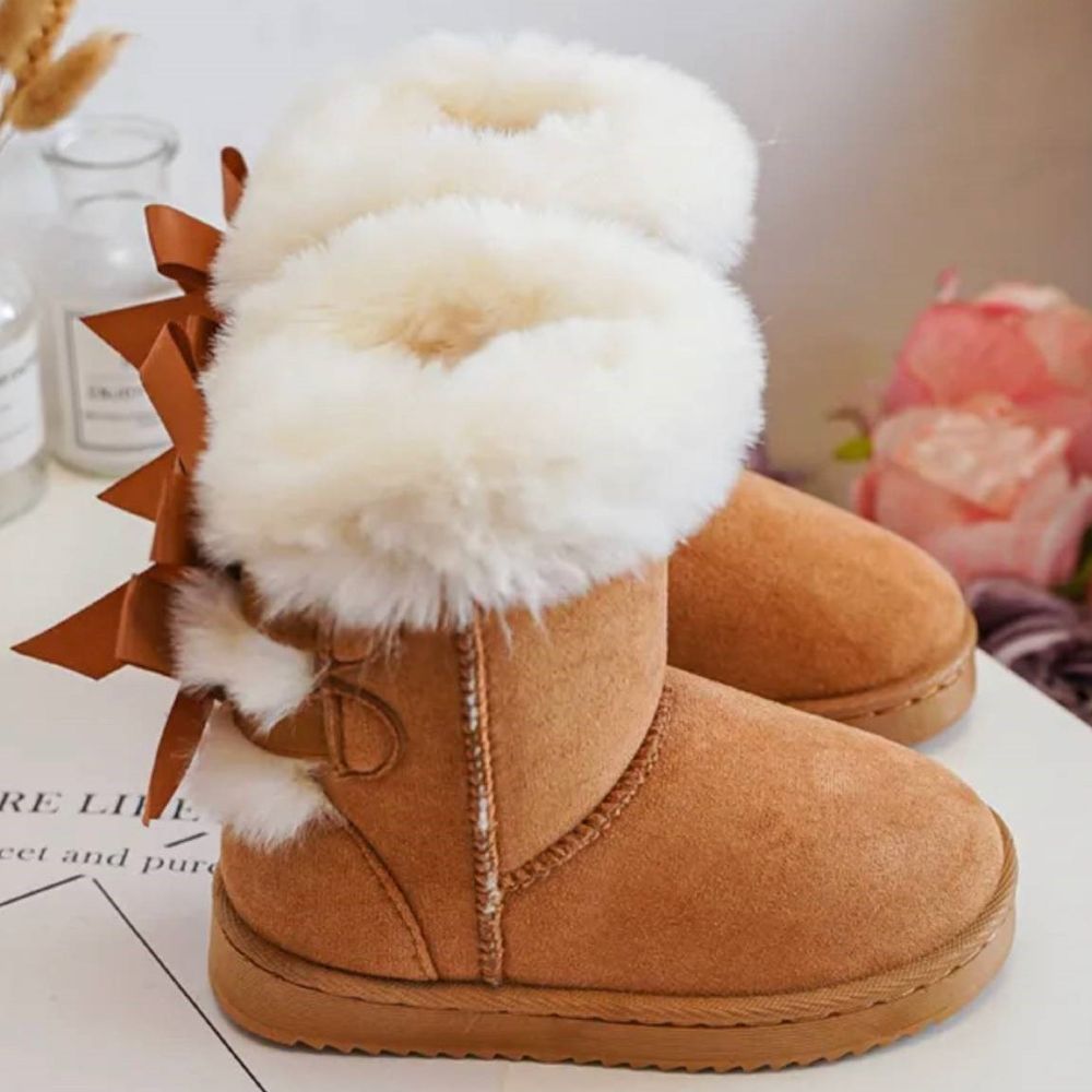 Children's tan suede boots with bows on the back and white fur lining 