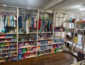 Interior of Polly and Tots children's boutique displaying children's clothes and accessories