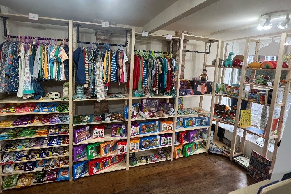 Interior of Polly and Tots children's boutique displaying children's clothes and accessories