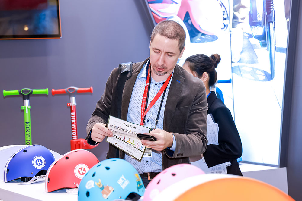 A buyer stood on a exhibition stand looking at the products and marketing materials