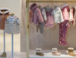 Children's clothes and shoes displayed on a stand at BKS + FIMI