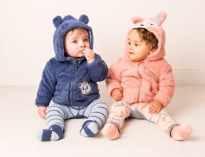 Two babies sat on the floor wearing hoodies with ears and leggings by Blade & Rose