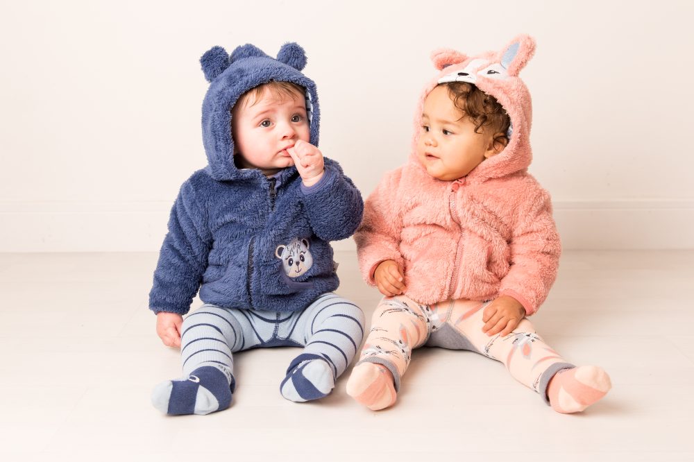 Two babies sat on the floor wearing hoodies with ears and leggings by Blade & Rose