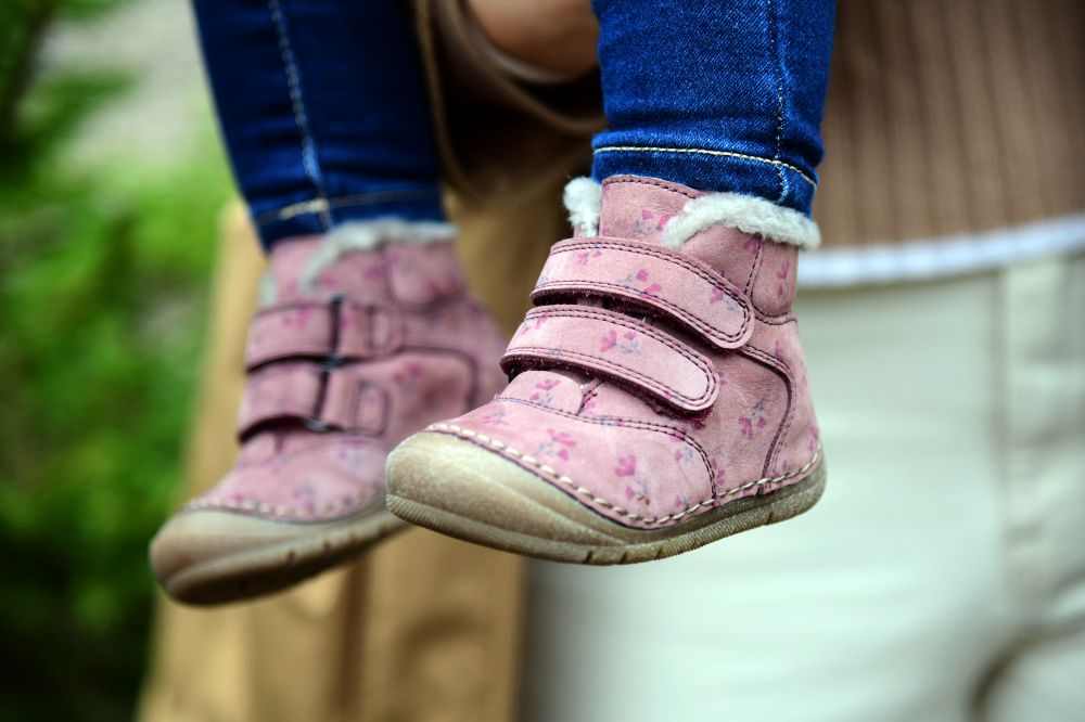 A child's feet wearing pink boots by Froddo