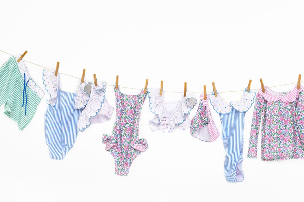 Children's swimwear by Lou Lou and friends hung on a line