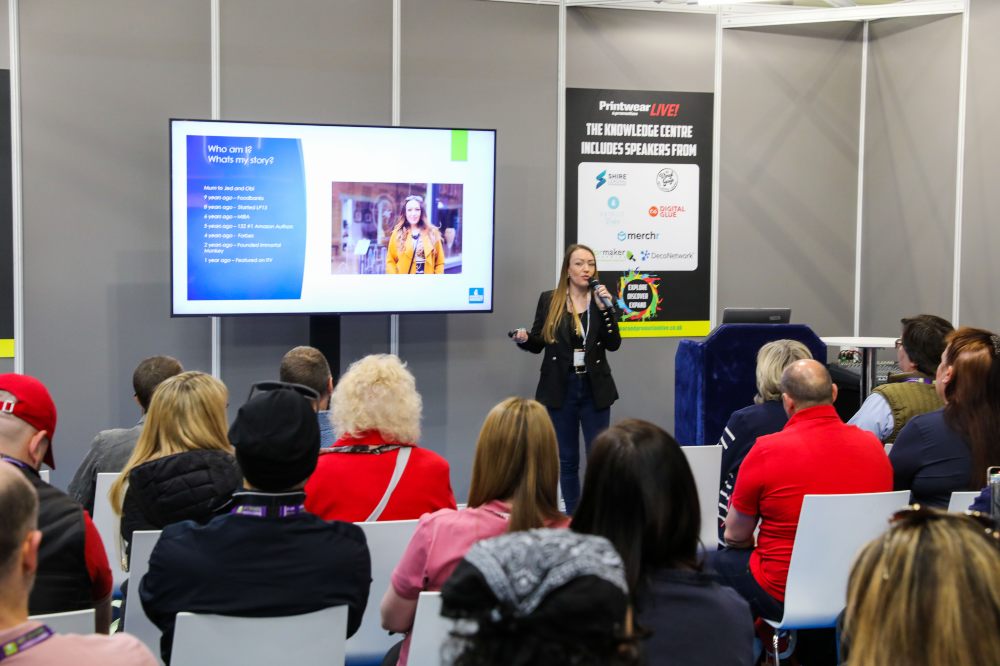 People sat in a seminar listening to a speaker at Printwear & Promotion LIVE!