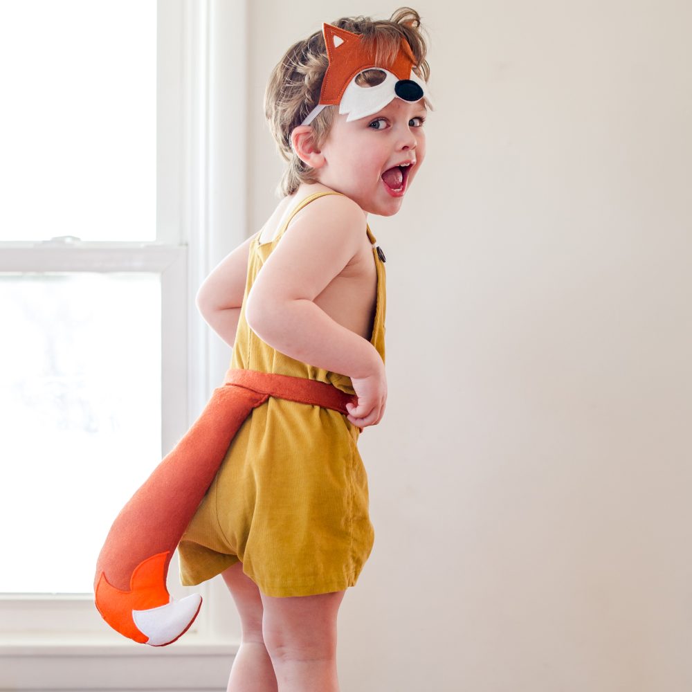 A young child wearing a yellow and orange fox costume by A is for Alice 