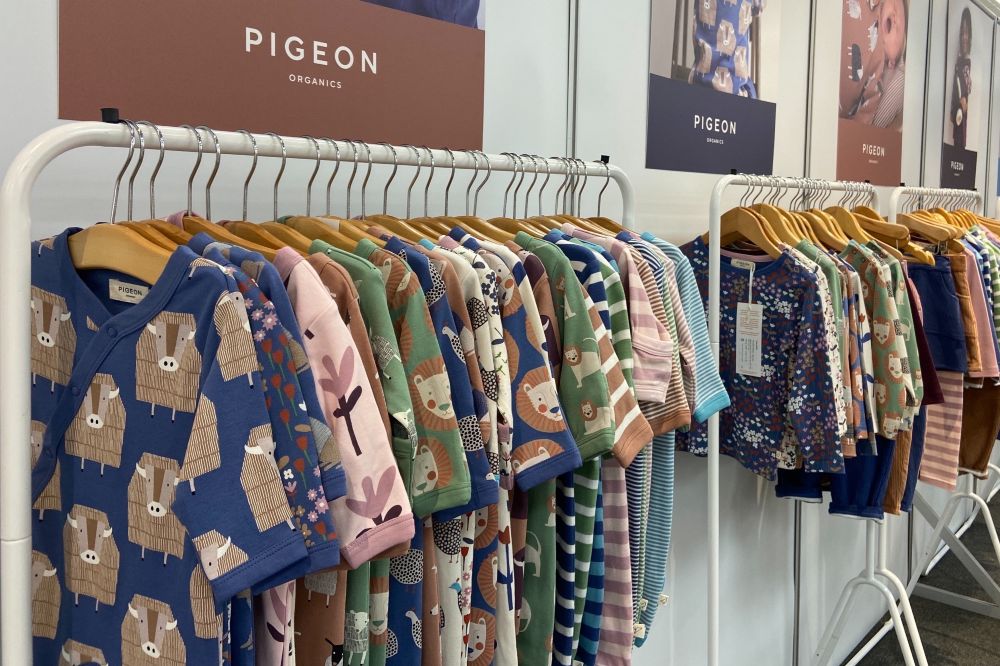 Children's clothes hung on rails on a stand at the INDX Kids trade show