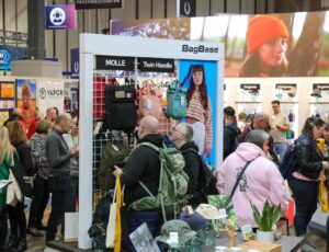 People on a stand at Printwear & Promotion LIVE! looking at bags