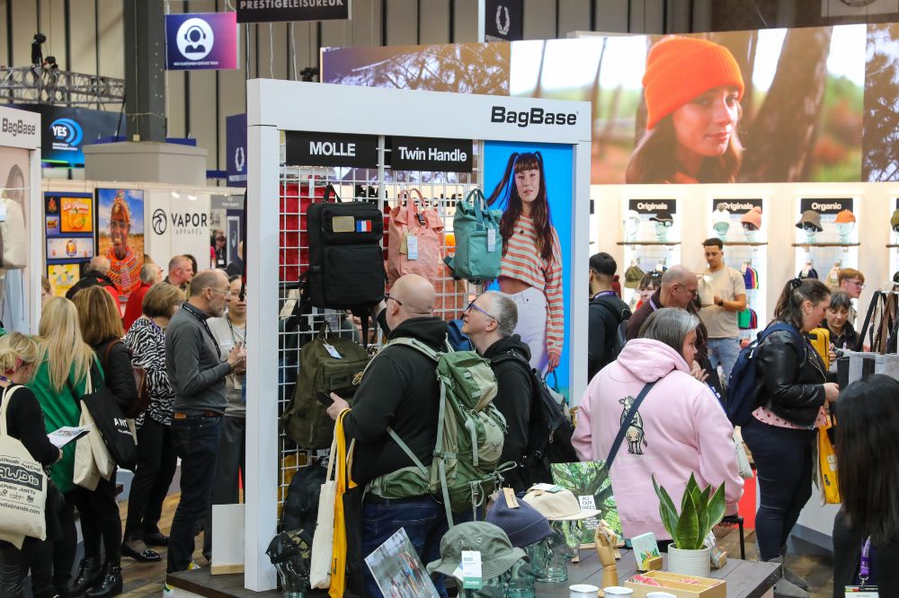 People on a stand at Printwear & Promotion LIVE! looking at bags
