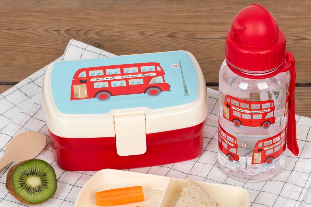A child's lunchbox and water bottle with a red London bus design