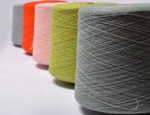 Different coloured cotton reels in a row