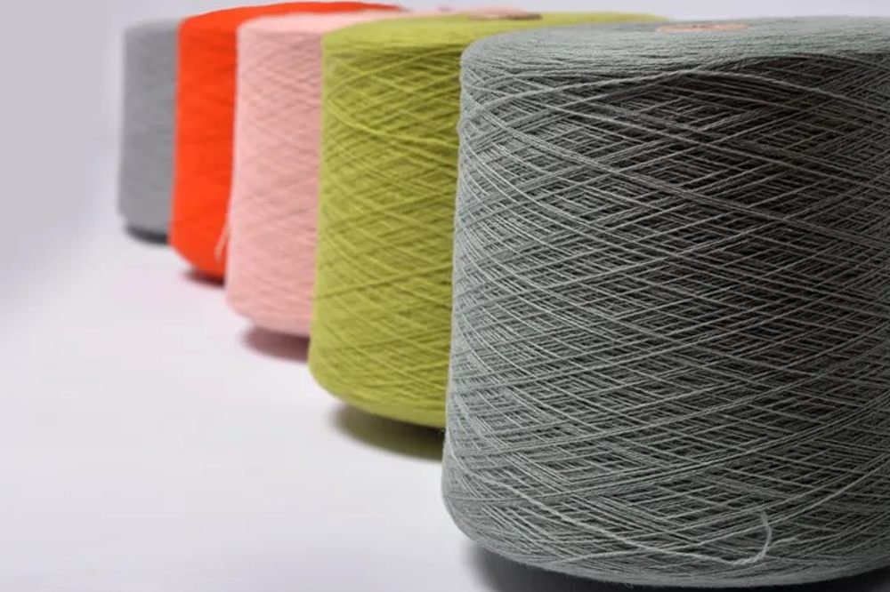 Different coloured cotton reels in a row
