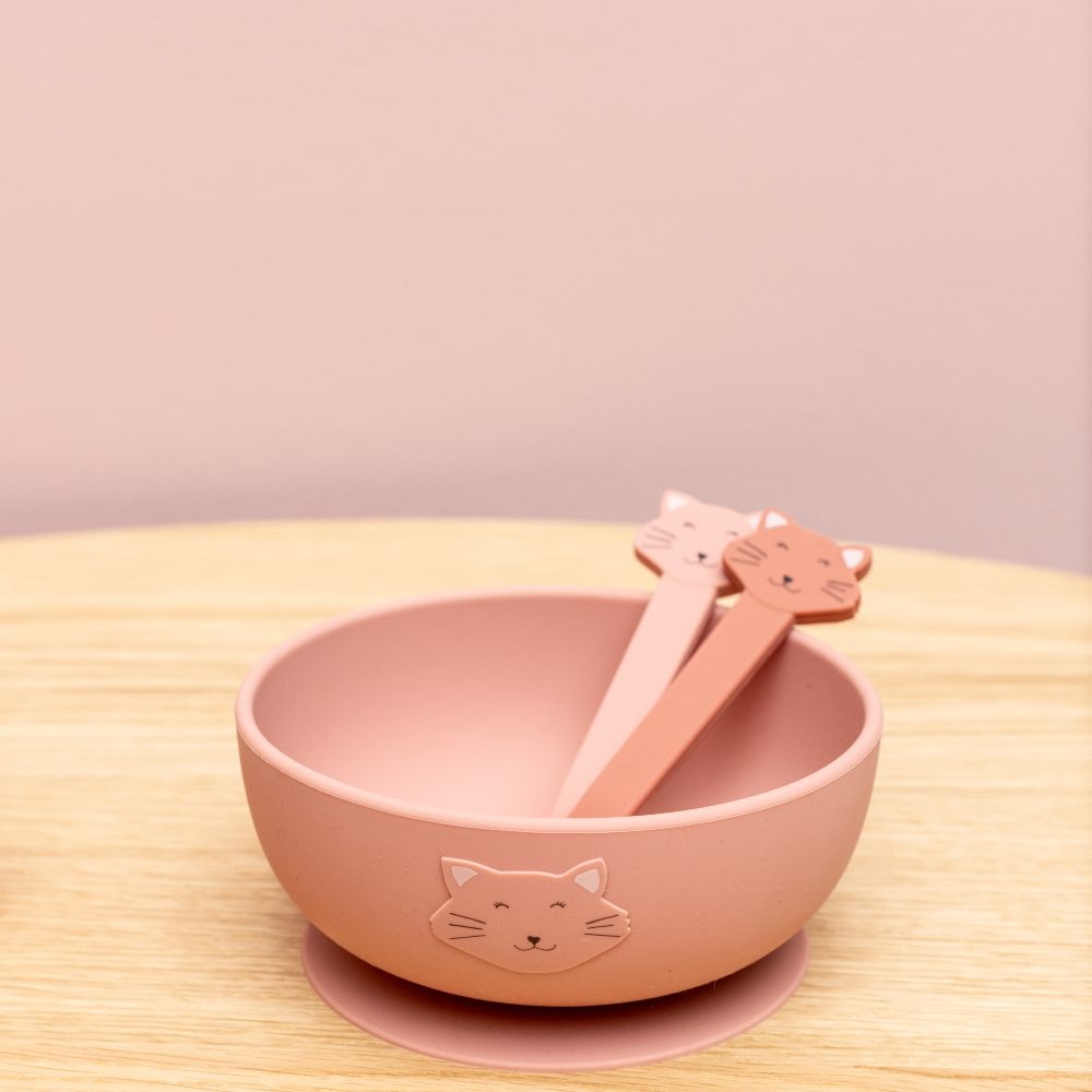 A pink children's bowl with pink cutlery in it