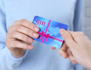 Two hands holding a blue gift card