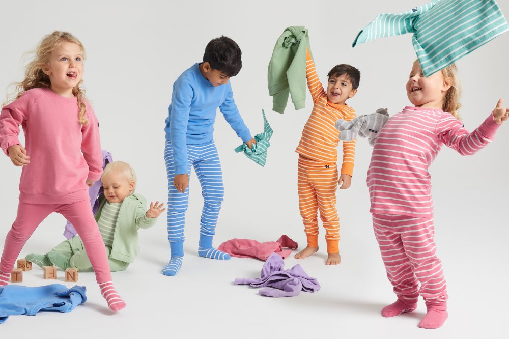 Children wearing different coloured striped tops and trousers