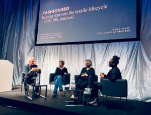 Three speakers on the stage with the host at Fashion 360