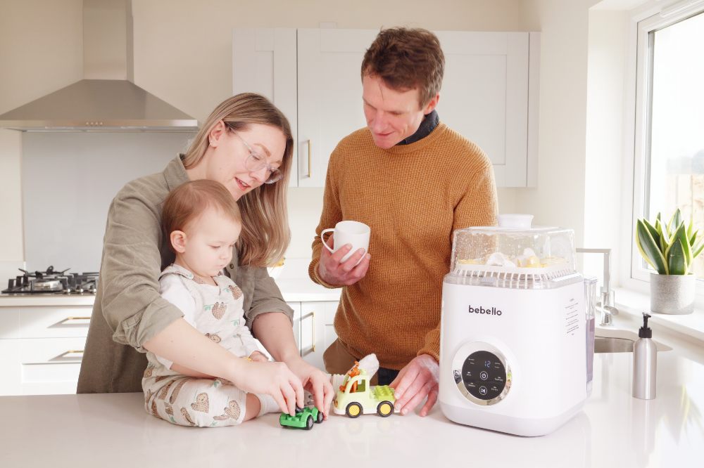 Parents in a kitchen with their child with a Bebello Washer on the top
