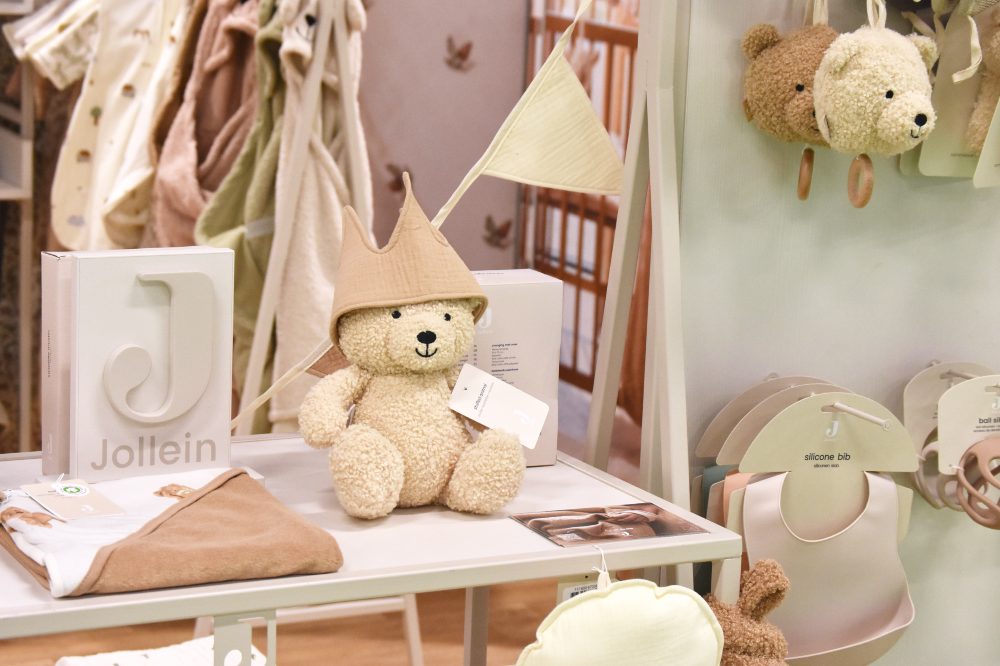 Baby products and a teddy displayed on a stand at Harrogate International Nursery Fair