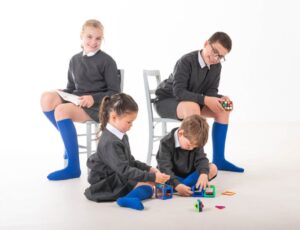 Four children in school uniform wearing by socks and tights by Pex