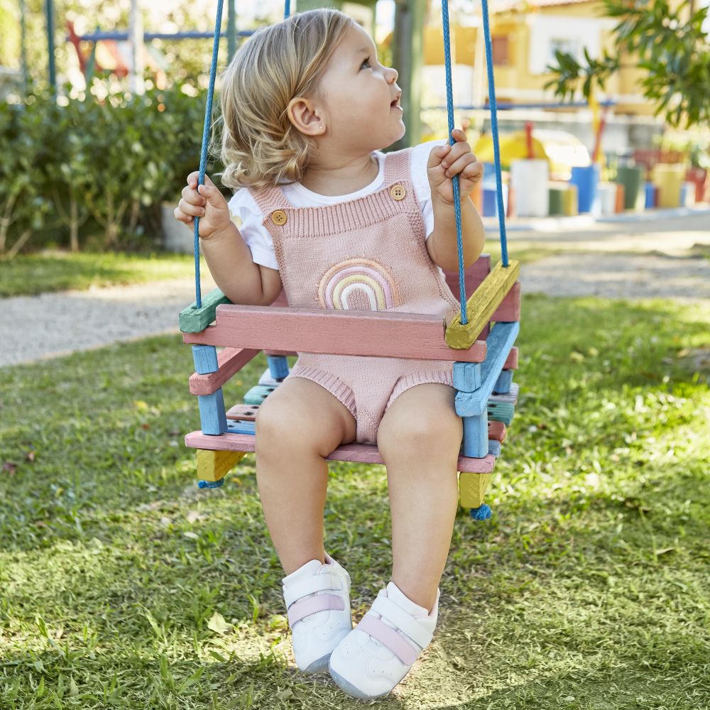 A young child sat on a swing 