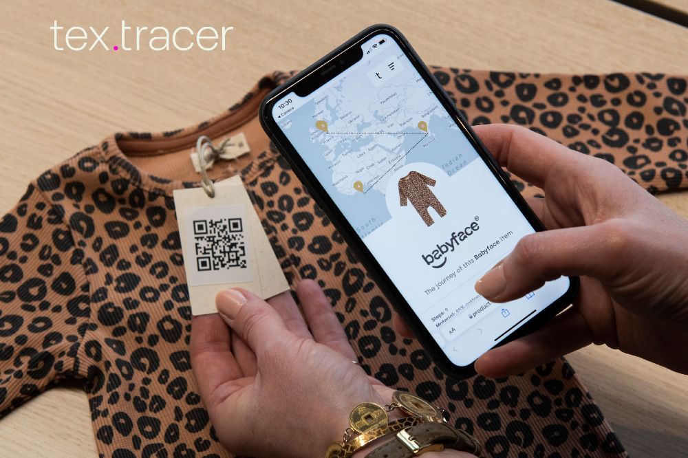 Someone scanning a label on a babygro with a mobile phone 