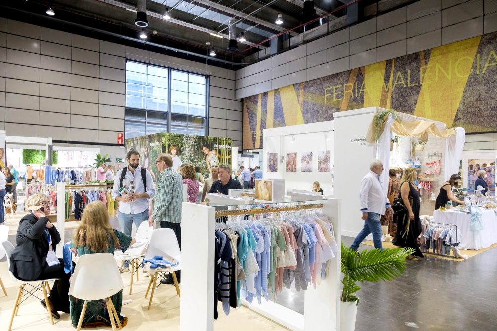 People walking around childrenswear stands at the FIMI trade show 