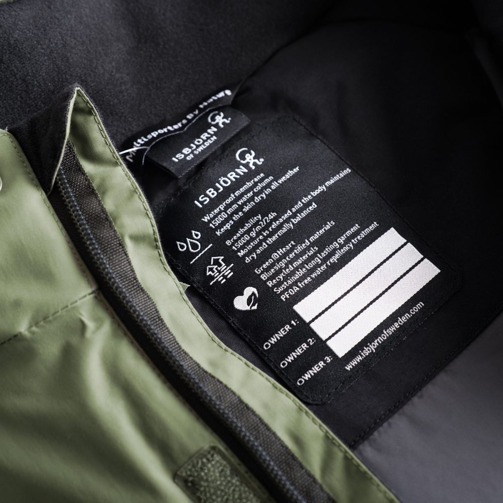 A label inside a child's jacket with space for three names 