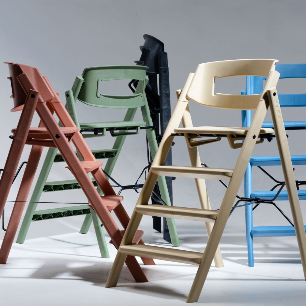 A selection of different coloured highchairs