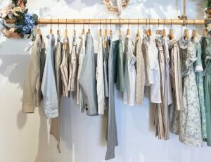 Children's clothes hung on a wooden rail in the Pepa London store