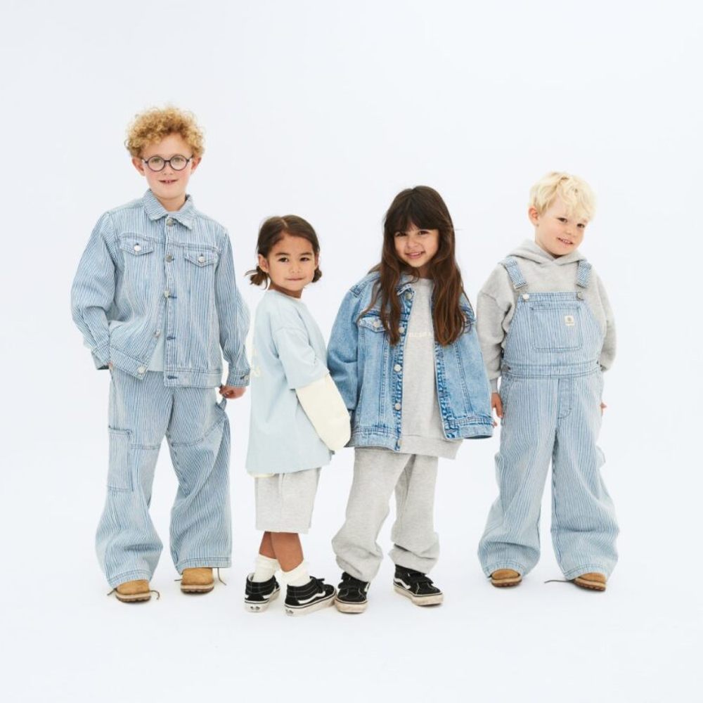 Four children stood side by side wearing denim outfits 