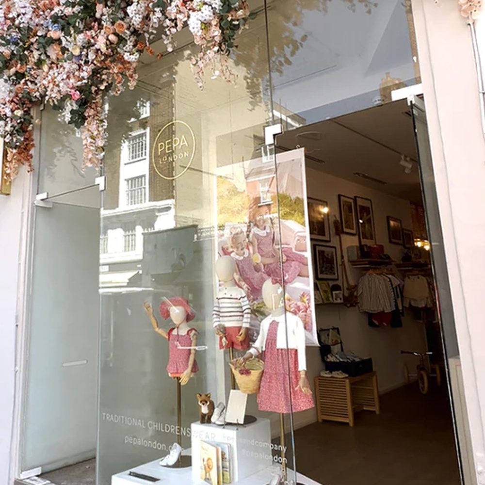 The Pepa London store front with flowers hung above the window and door