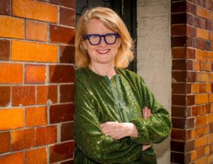 Head shot of Anna Pangbourne, chief executive of FTCT, stood in the doorway of a building wearing a green top