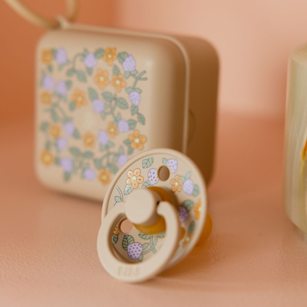 A floral print baby's pacifier and pacifier box 