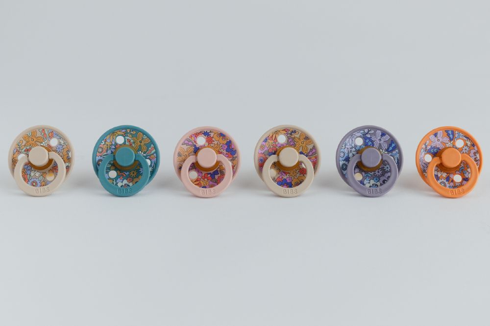 A line up of floral print pacifiers 