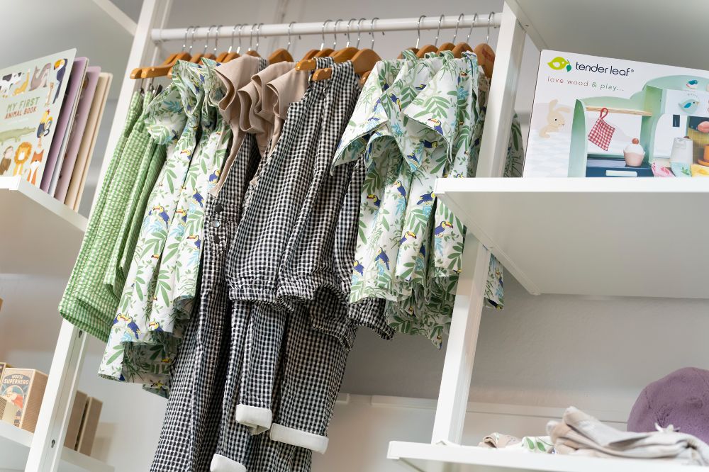 Rails and shelving displaying children's clothes and accessories in the Bloom & Alfie store 